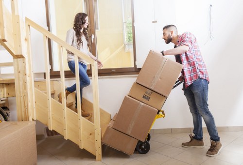 Removal movers protecting furniture inside a Wembley flat